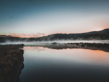 Scenic view of lake against sky during sunset