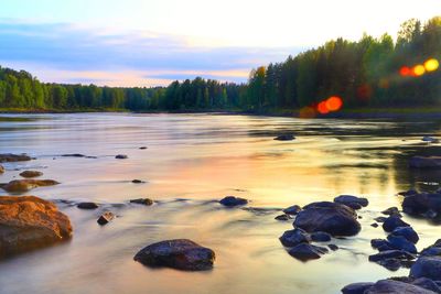 Scenic view of lake against sky during sunset