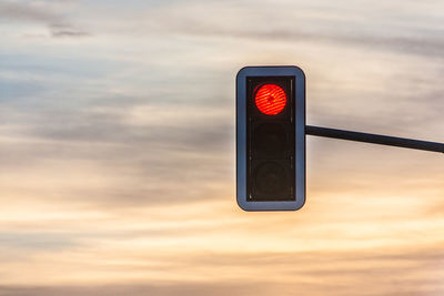 Low angle view of road sign against sky