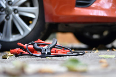 Close-up of work tool on road by car