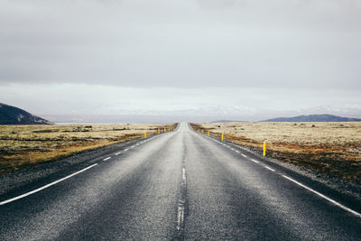 Country road against sky