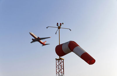 Low angle view of airplane against clear sky