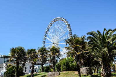 Low angle view of ferris wheel against clear sky