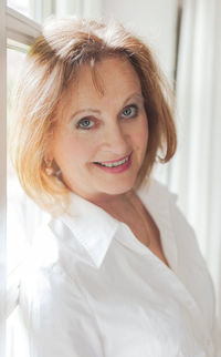 Close-up portrait of smiling senior woman at home