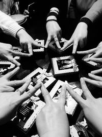 Cropped hands of women making star shape above gifts