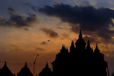 Low angle view of silhouette temple against sky during sunset