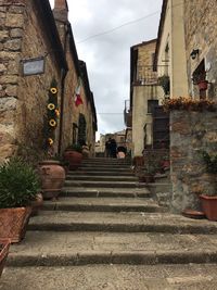 Staircase leading towards buildings in city