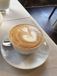 Close-up of cappuccino served on table