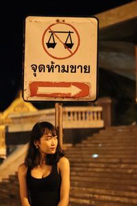 Portrait of a woman with road sign