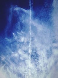 Low angle view of vapor trail in blue sky