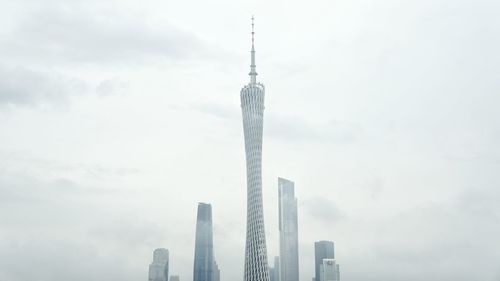 Low angle view of canton tower against sky in city