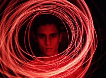 Close-up portrait of man with light painting at home