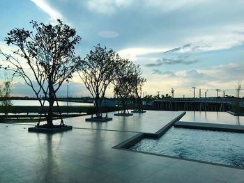 Swimming pool by sea against sky