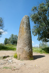 Built structure on field against clear blue sky