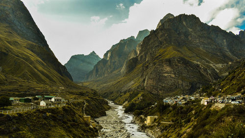 Scenic view of mountains against cloudy sky