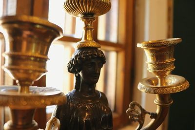 Close-up of antique statue on table