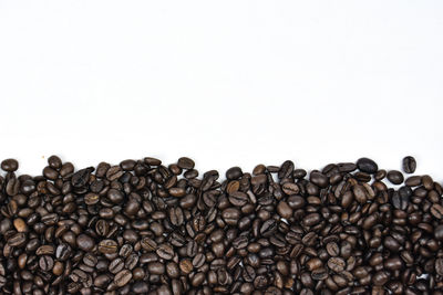 Close-up of coffee beans against white background