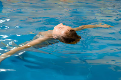 High angle view of woman swimming in pool