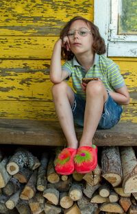 Full length of kid, sitting on bench