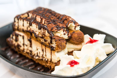 Close-up of tiramisu cake in container on table