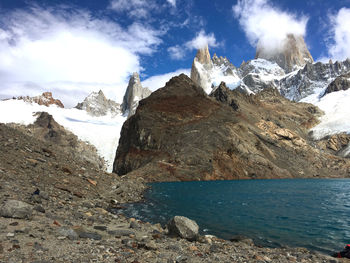 Scenic view of sea and mountains against sky