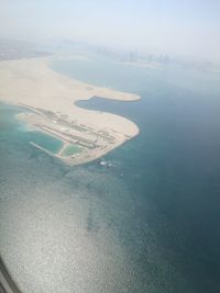 Aerial view of sea and airplane wing