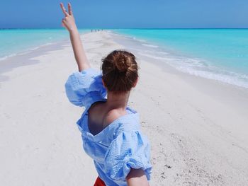 Rear view of boy on beach