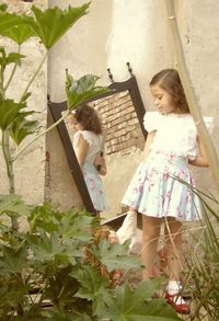 Women standing by plants