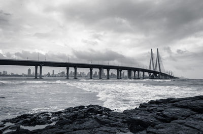 Bridge over sea against sky