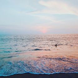 Scenic view of beach against sky during sunset