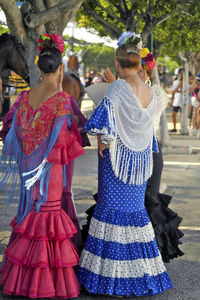 Rear view of women standing outdoors