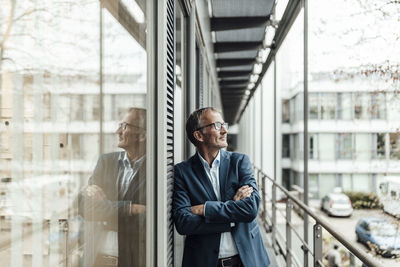 Full length of man standing by window