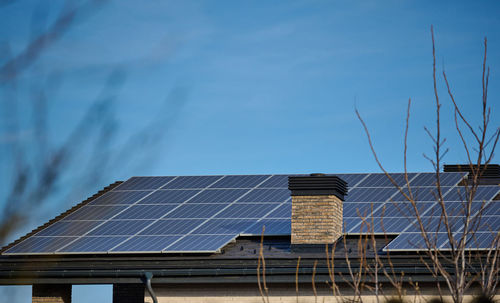 Roof of a residential building with solar panels. green energy and energy independence concept