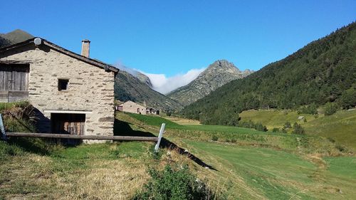 Scenic view of mountains against clear blue sky