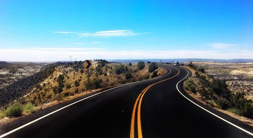 Road passing through landscape against sky