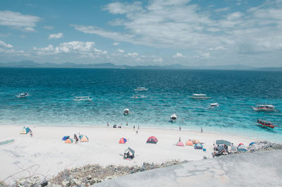 People on beach against sky