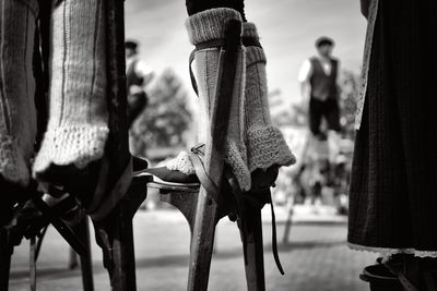 Low section of shoes hanging outdoors