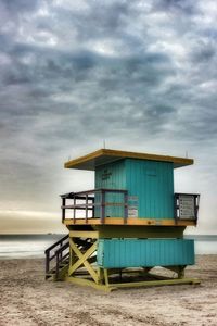 Lifeguard hut on beach against sky