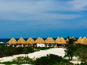 Built structure on beach against blue sky