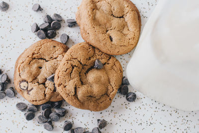 Close-up of cookies with milk on table