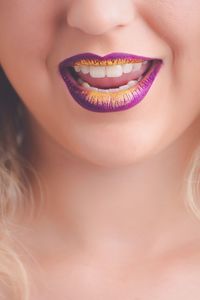 Cropped image of woman with purple lipstick