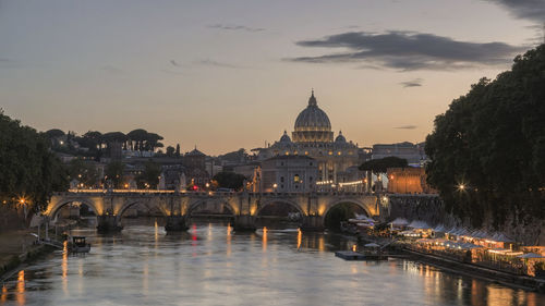 Ponte sant angelo over tiber river in city during sunset