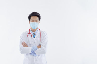 Portrait of man standing against white background