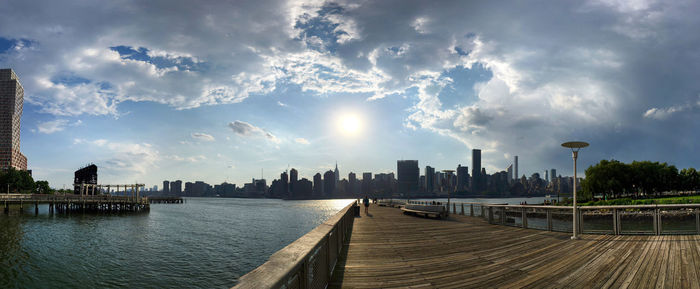 Cityscape against cloudy sky