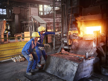 Industry, smeltery: workers checking blast furnace for fractures