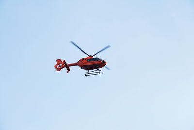 Low angle view of helicopter flying in sky