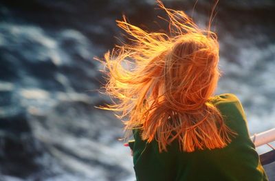 Rear view of woman with blond hair at windy weather