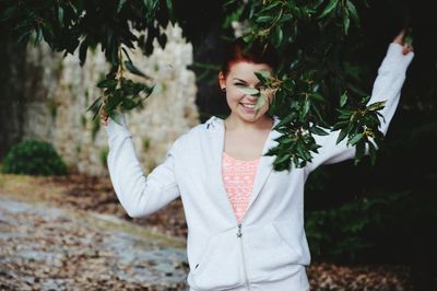 Portrait of young woman standing outdoors