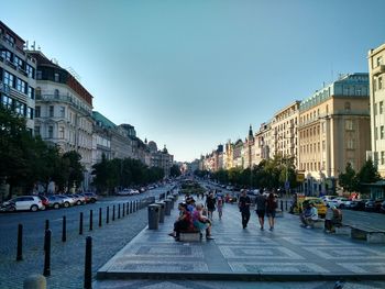 People on road amidst buildings in city