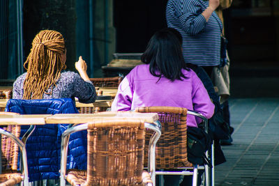 Rear view of people sitting on chair